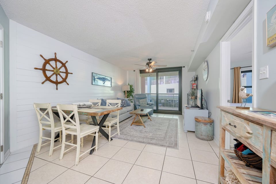 Cozy living room with comfy seating and coastal decor invites you to relax after a day at the beach