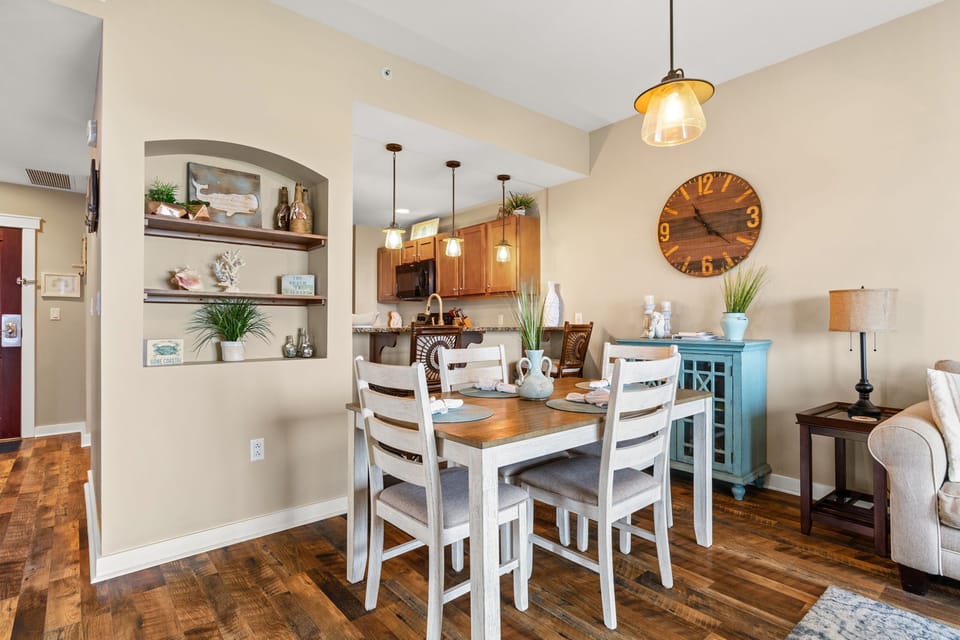 Enjoy intimate meals at your charming dining table, where built-in shelving displays thoughtful touches and warm pendant lighting creates the perfect ambiance.