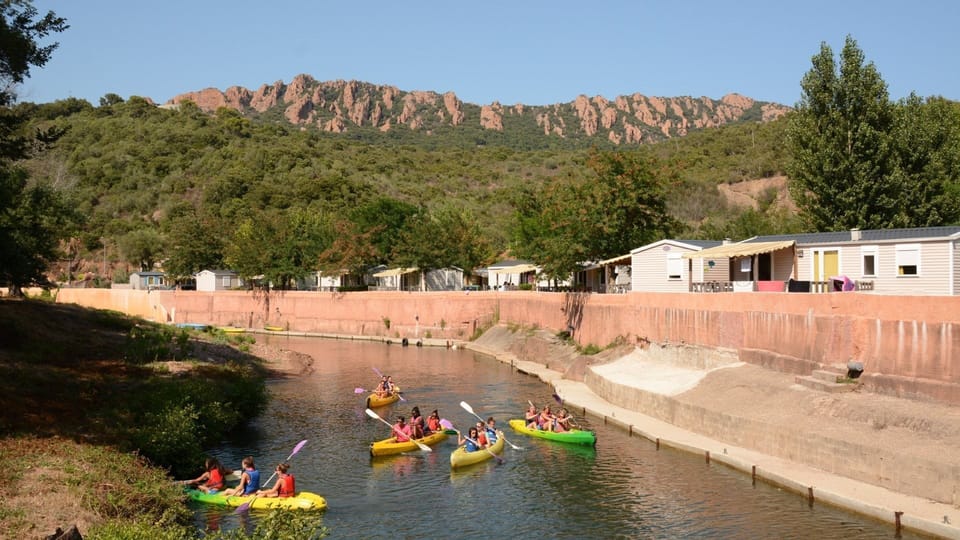 Glide through gentle river currents, framed by the majestic red cliffs of the Estérel massif.