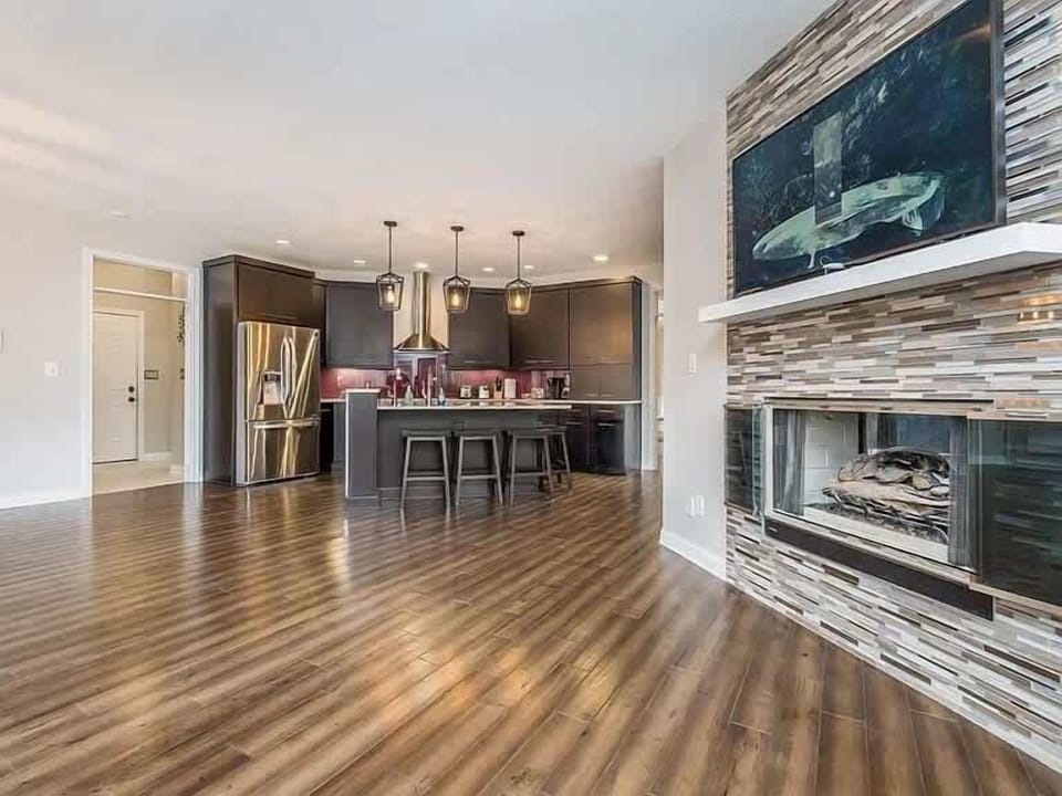 Sleek kitchen w/ long island, fireplace & open layout for entertaining