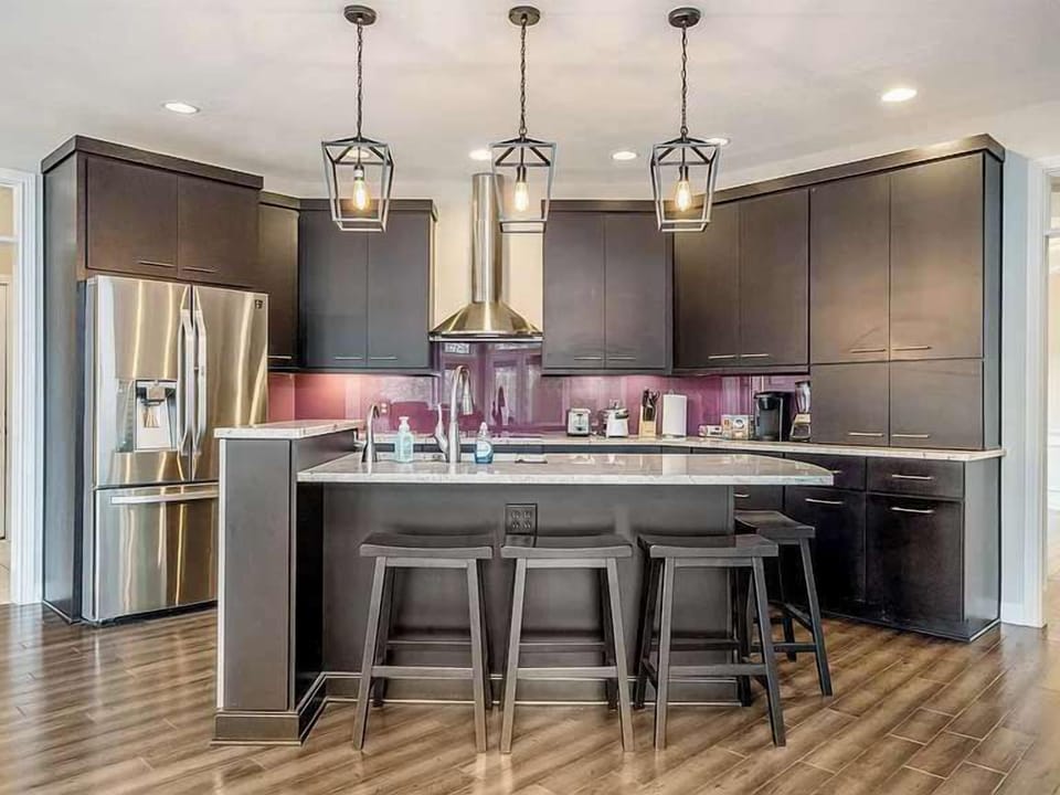 Modern kitchen w/ island seating, pendant lighting & sleek cabinetry for easy meals
