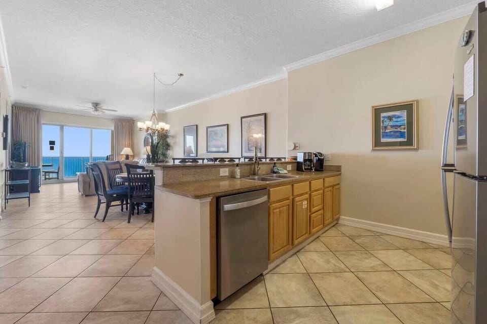 Fully Stocked Kitchen with Stainless Steel Appliances and Island Bar Seating