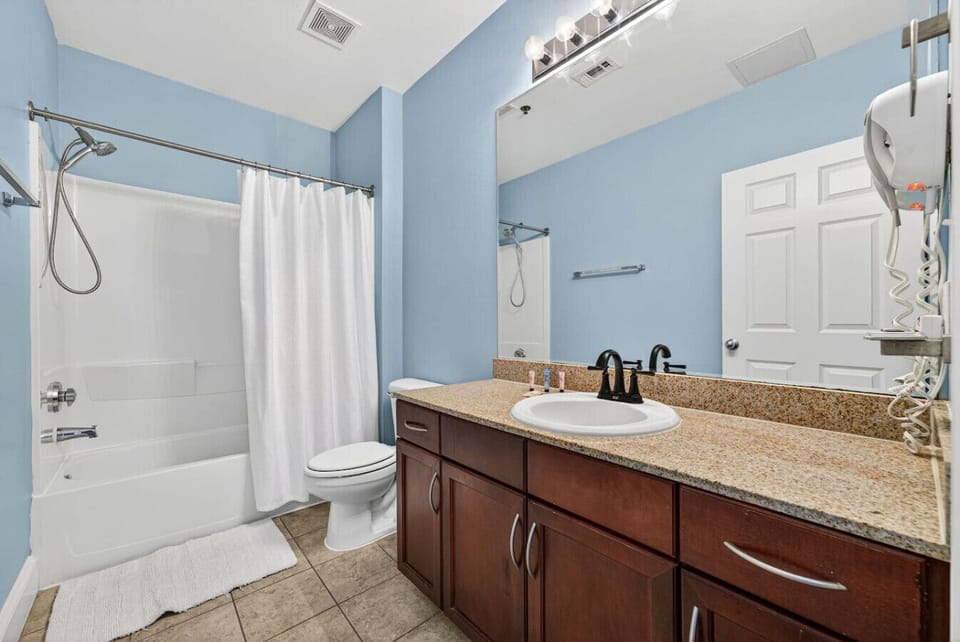Spacious full bathroom with granite countertops and a tub/shower combo for added comfort.
