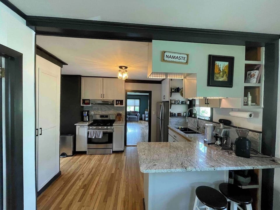 Our recently remodeled kitchen, sports stylish granite countertops. There is espresso, coffee, toaster and a stove with a pancake burner. 