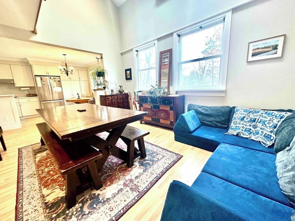 A full length table in the dining room where 10 can comfortably sit. The couch here doubles as an extra bed. 