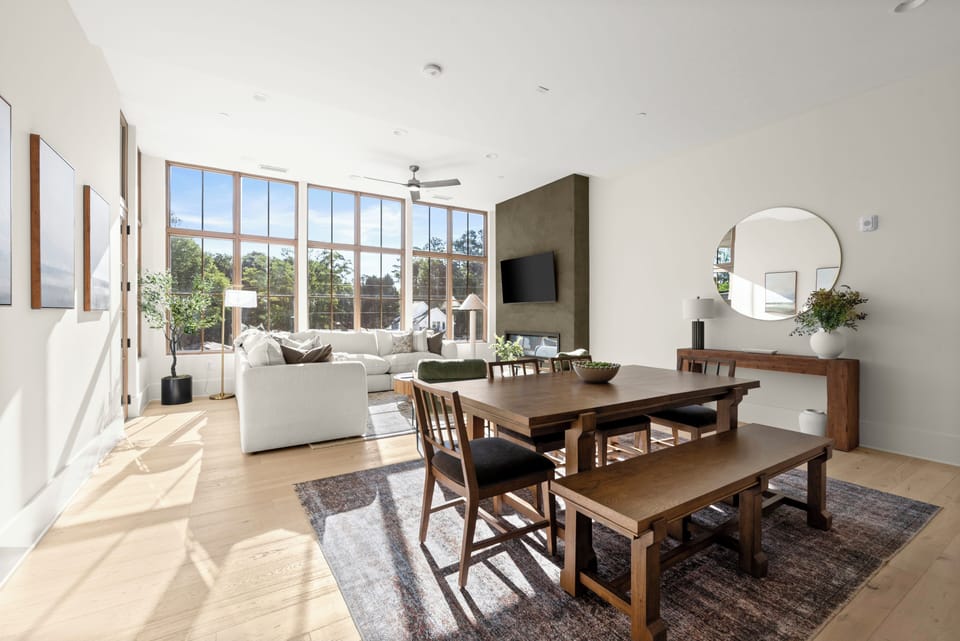 Bright open-plan lounge & dining, wall TV, seats 6–8, treetop views.