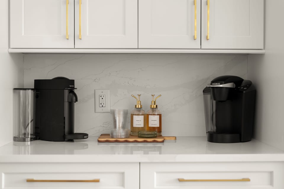 Sleek coffee bar with dual brewers, cups, and all the essentials.