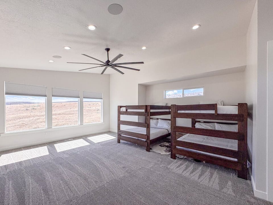 Spacious bunk room with double sets of beds and expansive countryside views