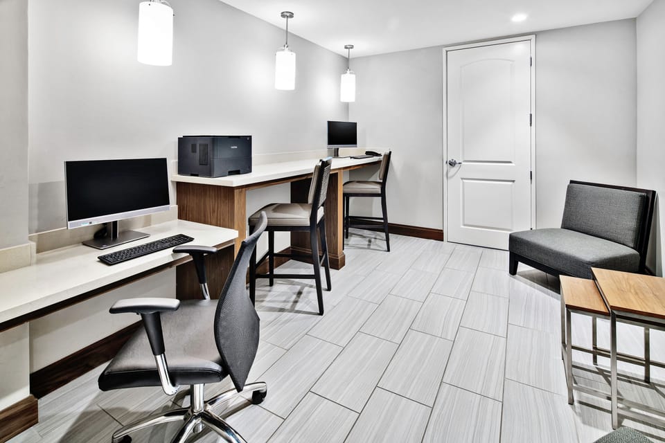 Additional business center seating and workspace area.