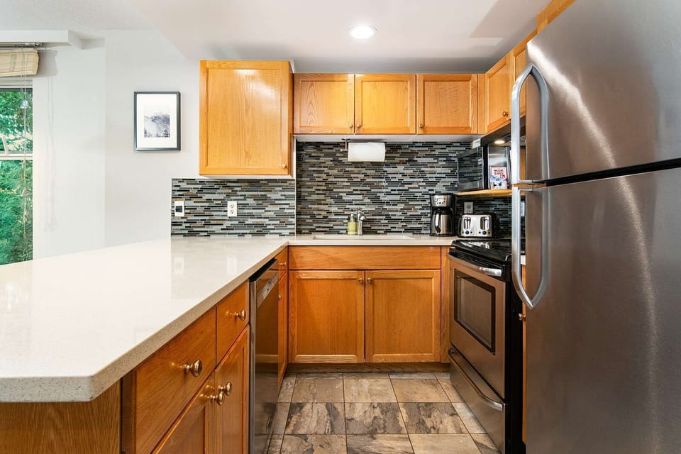 
- Modern kitchen with stainless steel appliances and sleek finishes - Fully equipped for home-cooked meals during your mountain getaway - Spacious island seating perfect for breakfast or evening wine