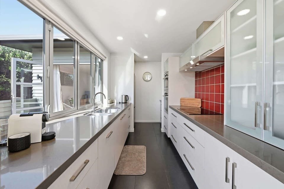 Galley kitchen with stone benchtops
