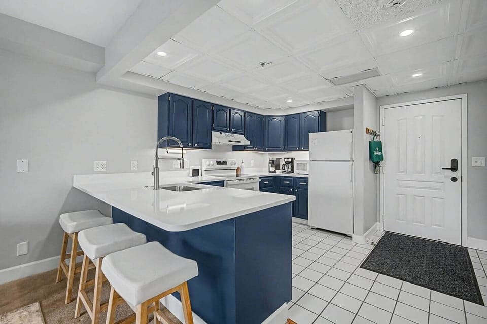 Fully stocked kitchen with large quartz counter seating
