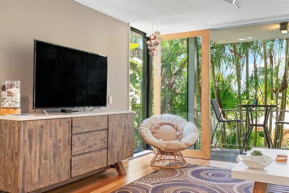 Large smart TV and large sliding doors that open up onto your private balcony.