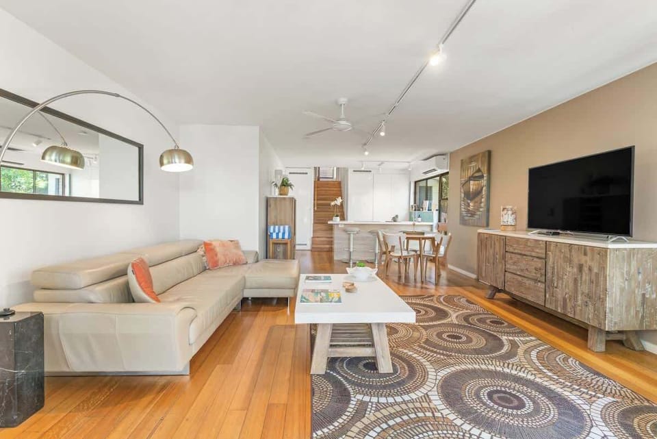 Light filled living space flowing from the large balcony doors through to the kitchen.