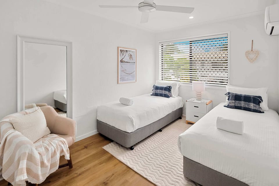 Two comfortable single beds make the second bedroom ideal for children