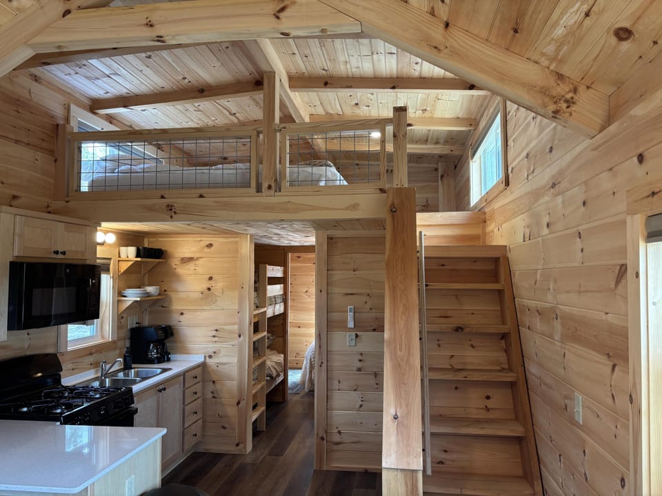 Cozy cabin kitchen and loft with warm wood accents