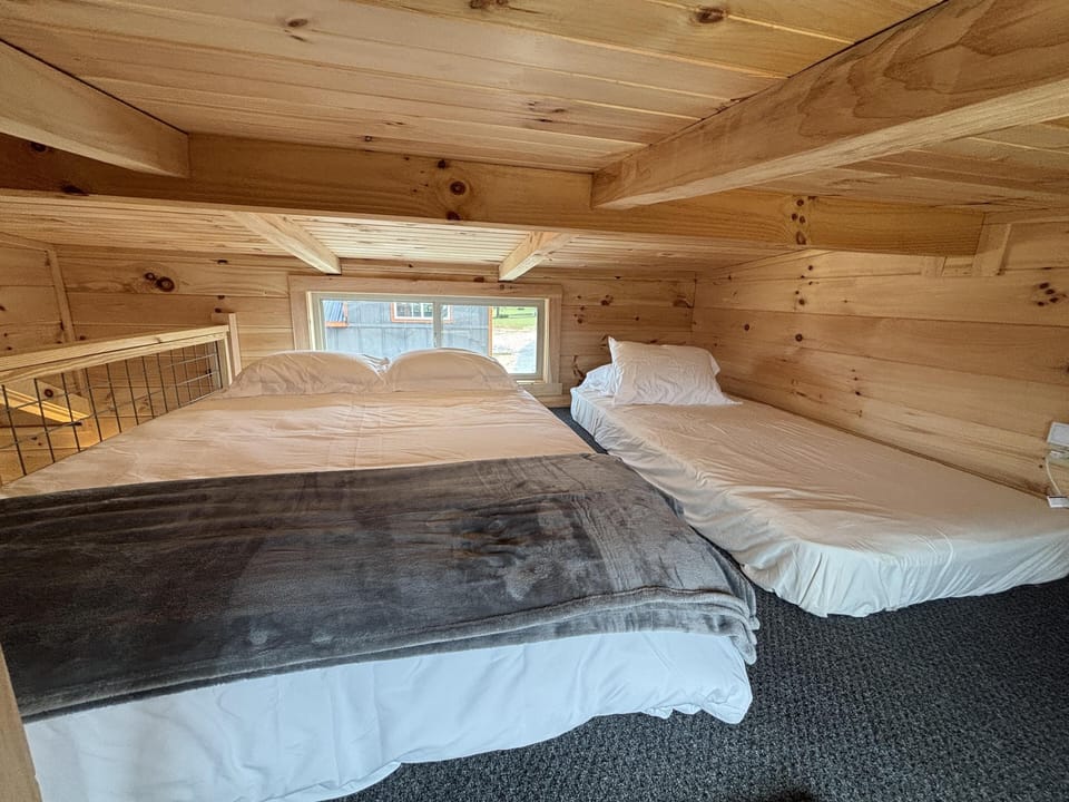 Cozy loft bedroom with warm wood accents and natural light