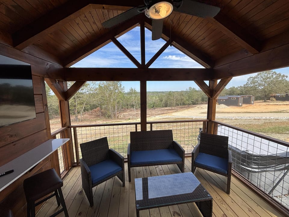 Cozy screened porch with vaulted ceiling and scenic views