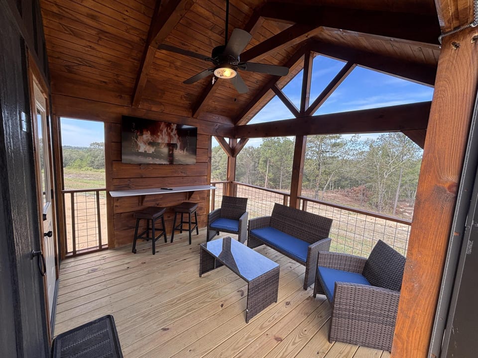 Spacious screened porch with cozy seating and scenic views