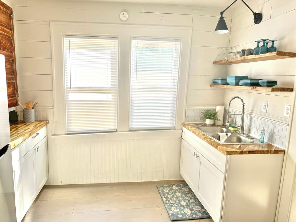 Full kitchen: Fridge, Stove, Microwave, Coffee Pot, Toaster, Electric Kettle, Knives, Silverware, Dishes, Pots & Pans, Basic cooking supplies (spices, oil, sugar, flour, coffee), Cutting board, cooking utensils 