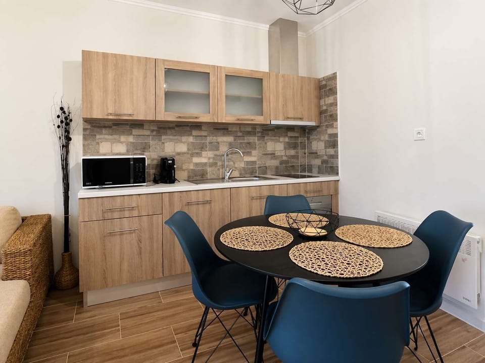 A closer view of the kitchen and dining space, with modern finishes and everything arranged for straightforward cooking and shared meals.