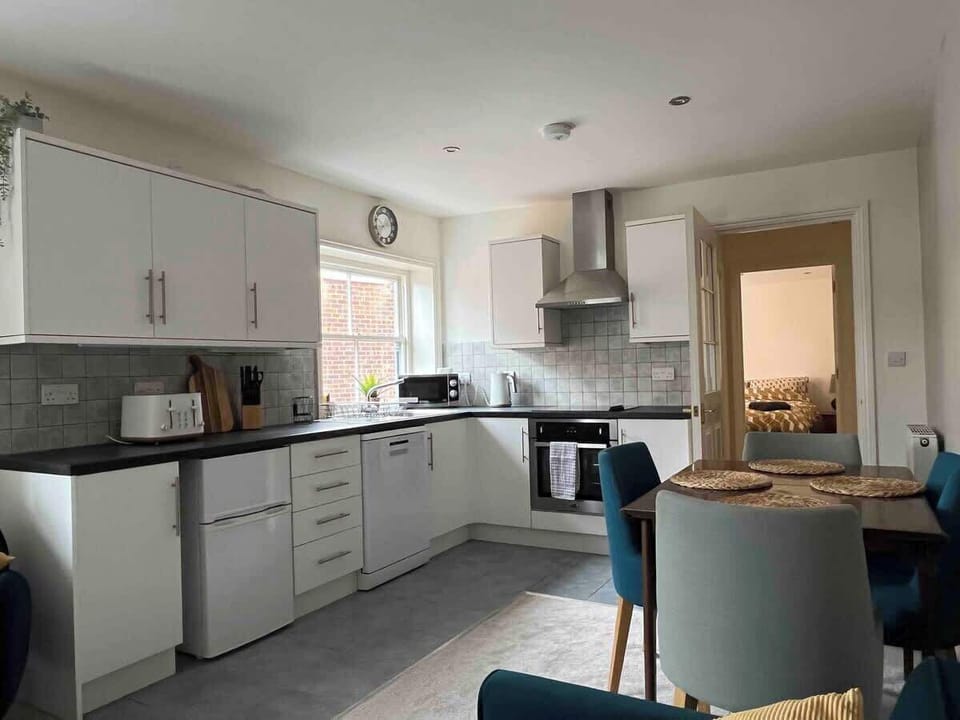 Kitchen area with fridge-freezer, dishwasher, electric oven and halogen hob.