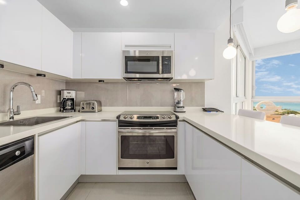 Cook your favorite meals in this modern kitchen while enjoying stunning ocean views through the large window.