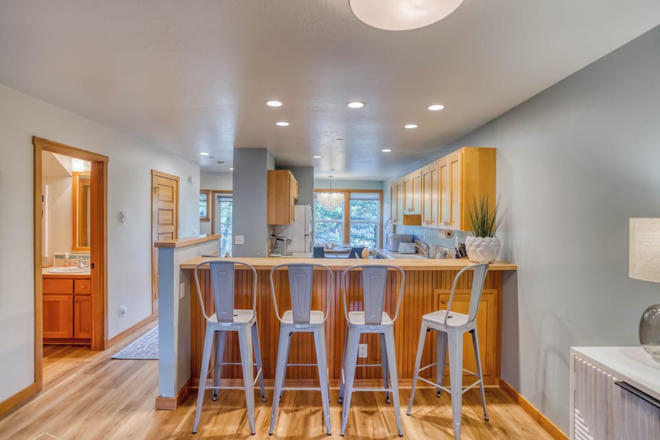 Cook your favorite meals in this bright, modern kitchen with a breakfast bar perfect for morning coffee or casual dining.