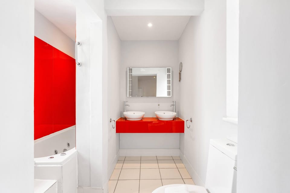 Updated bathroom space with smooth countertop basin and practical toilet area