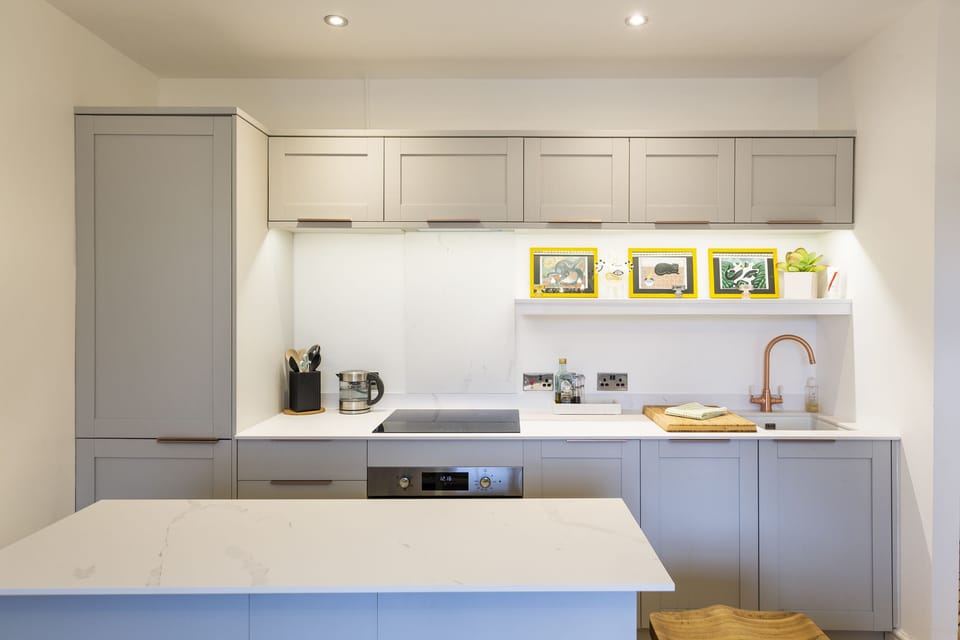 A fully equipped kitchen featuring a stylish island 