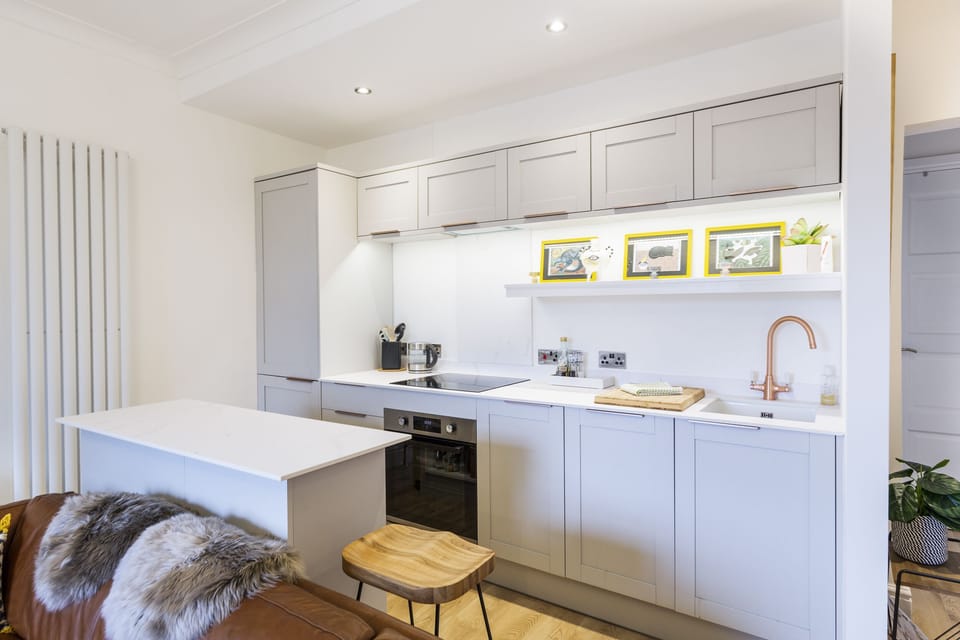 A fully equipped kitchen featuring a stylish island 