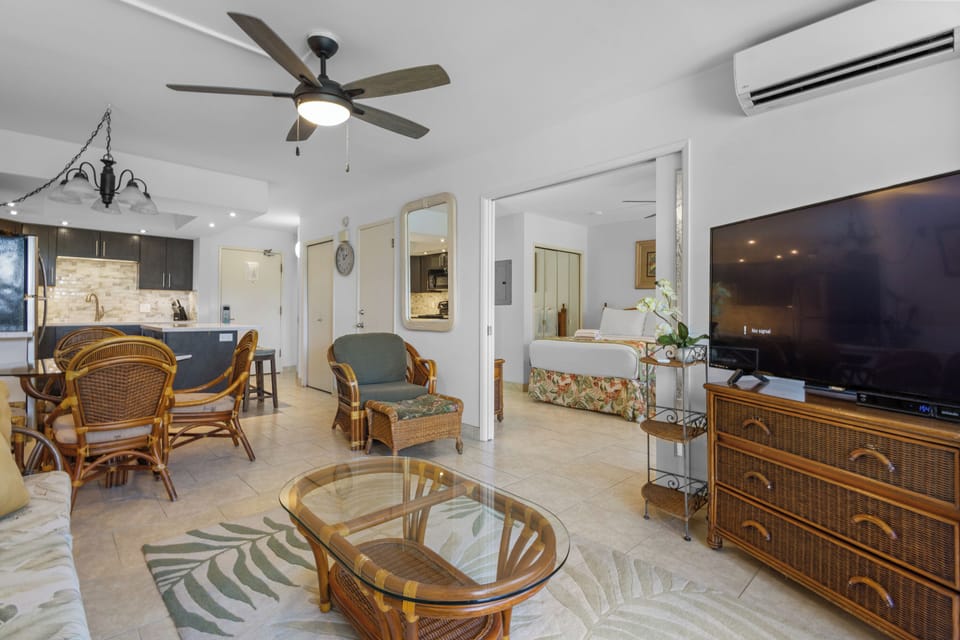 Relax in your tropical-inspired living space with wicker furnishings, cool tile floors, and modern comforts like AC and ceiling fan.