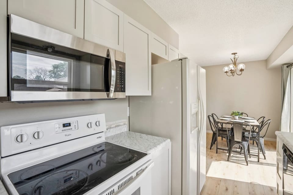 Kitchen | Unit 2 | Main Floor
Full kitchen with electric range and oven, microwave, and full-size refrigerator. Counter space for meal preparation and cabinet storage. Located next to the dining area for convenient serving.