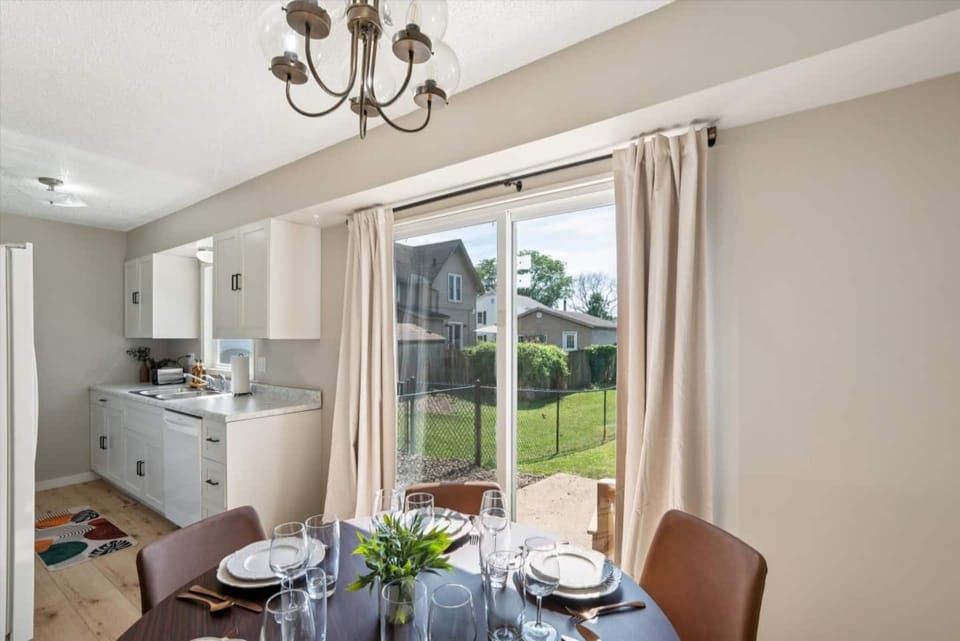 Dining Area | Unit 1 | Main Floor
Dining table with seating for four guests. Located next to the kitchen for easy meal prep and serving. Sliding glass door provides direct access to the backyard patio. Shared dining space within Unit 1.