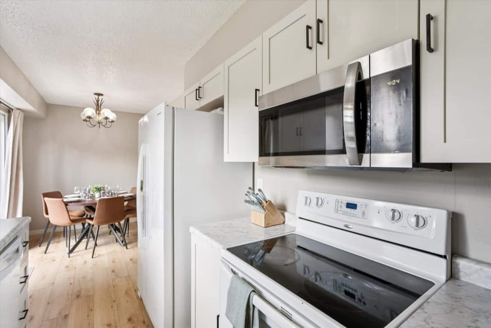 Kitchen | Unit 1 | Main Floor
Full kitchen with electric range and oven, microwave, and full-size refrigerator. Counter space for meal preparation and cabinet storage. Located adjacent to the dining area.