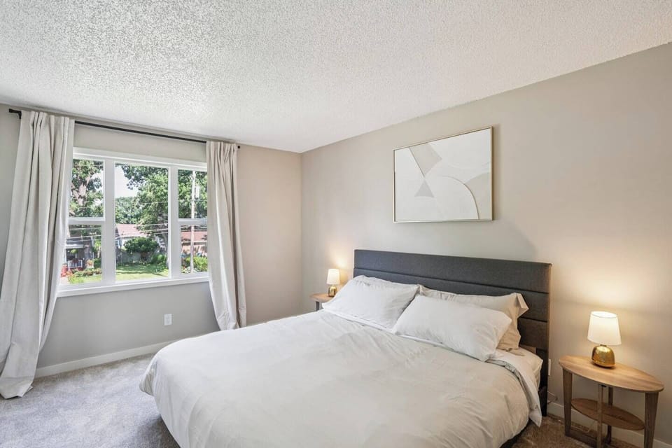 King Bed | Unit 2 | Top Floor
A king bed sleeps two guests. Nightstands on both sides of the bed. Closet storage available. Room-darkening blackout shades. Access to a shared full bathroom on the same floor.