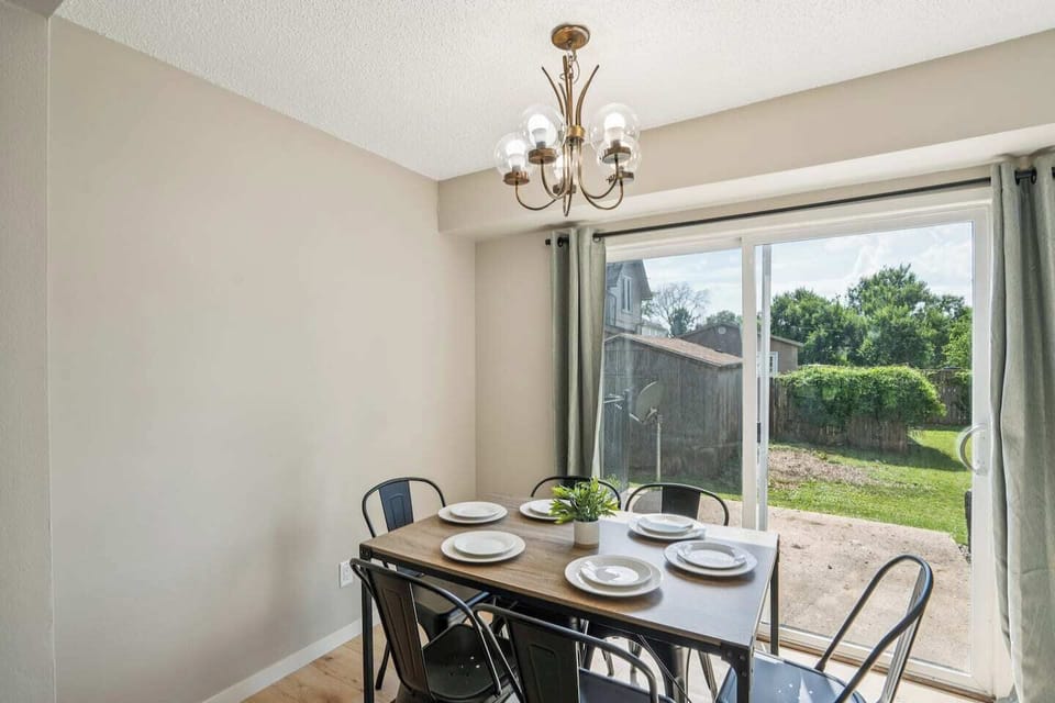 Dining Area | Unit 2 | Main Floor
Dining table with seating for four guests. Located adjacent to the kitchen. Sliding glass door provides direct access to the backyard patio. Shared dining space within Unit 2.