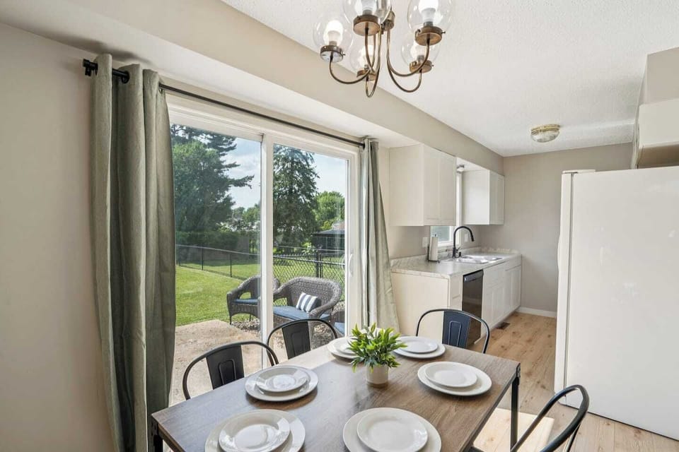 Dining Area | Unit 2 | Main Floor
Dining table with seating for four guests. Located next to the kitchen. Sliding glass door provides direct access to the backyard patio. Shared dining space within Unit 2.