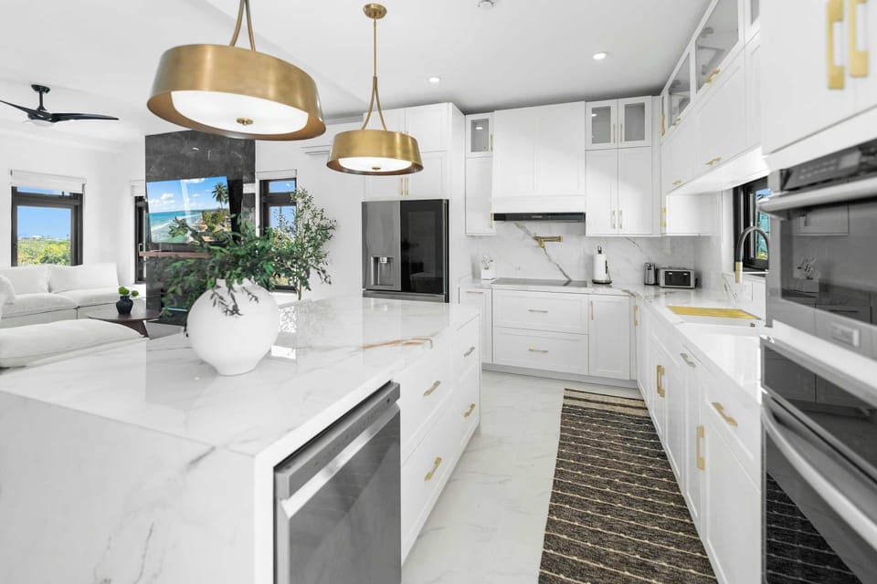Modern cabinetry and marble counters in the chef's kitchen.