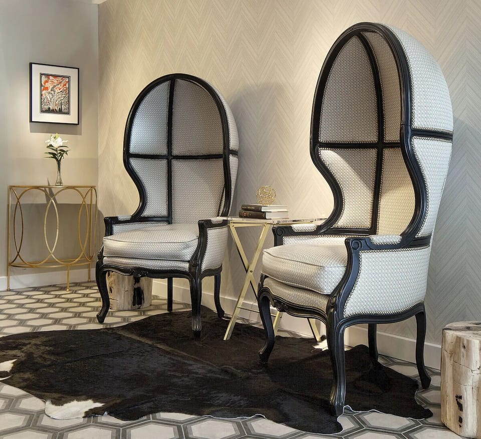 Sink into sculptural chairs for a quiet, luxe pause.