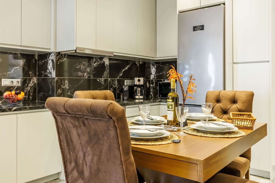 Fully equipped kitchen and inviting dining space perfect for home-cooked meals. Enjoy modern appliances, stylish finishes, and a welcoming atmosphere for shared moments