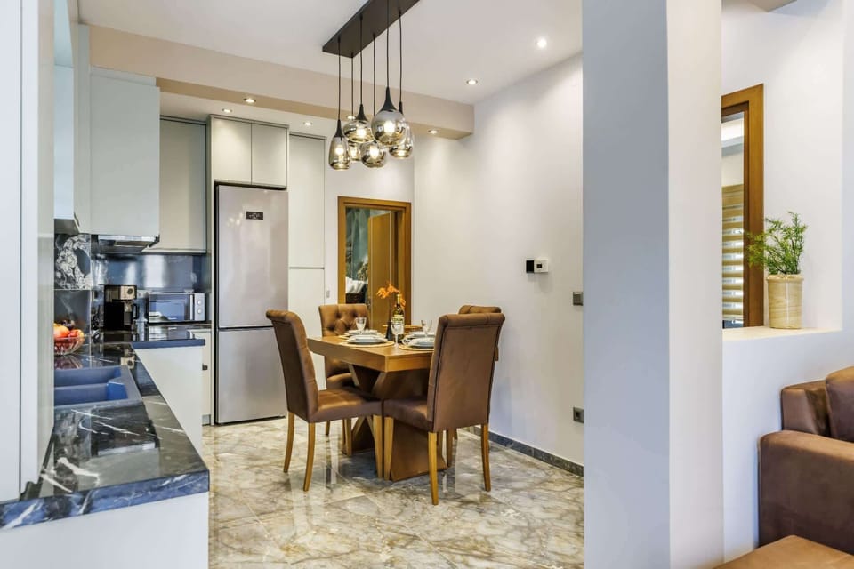 Modern open kitchen seamlessly connected to the dining area. Perfect for preparing meals or relaxing