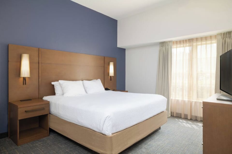 Drift off in a quiet king room with sunny windows.
