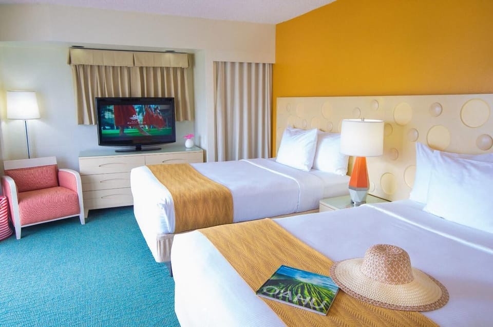 Unwind in bright double beds with easy entertainment nearby.