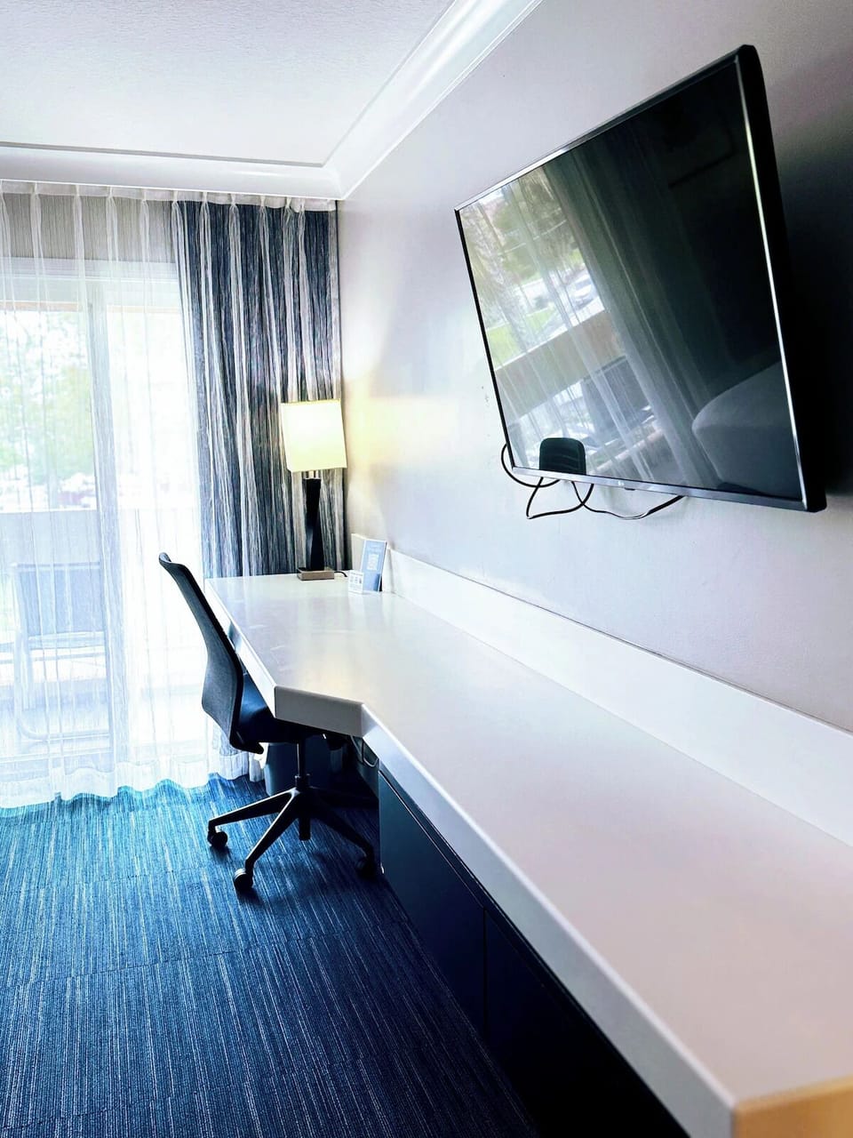 Get productive at the long desk beside bright window light.
