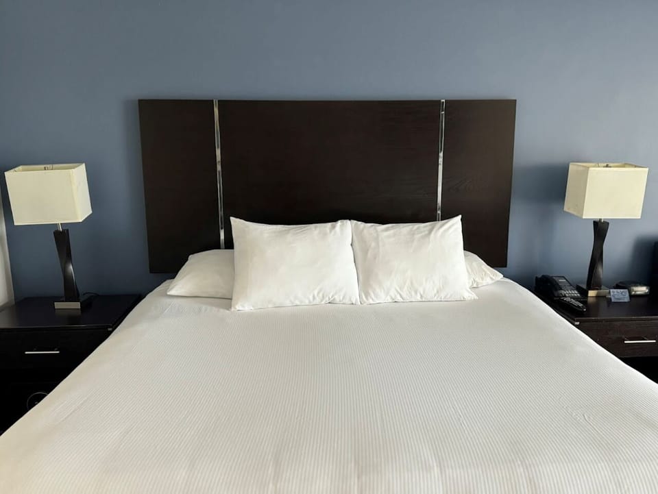 Settle in with plush pillows and balanced bedside lighting.