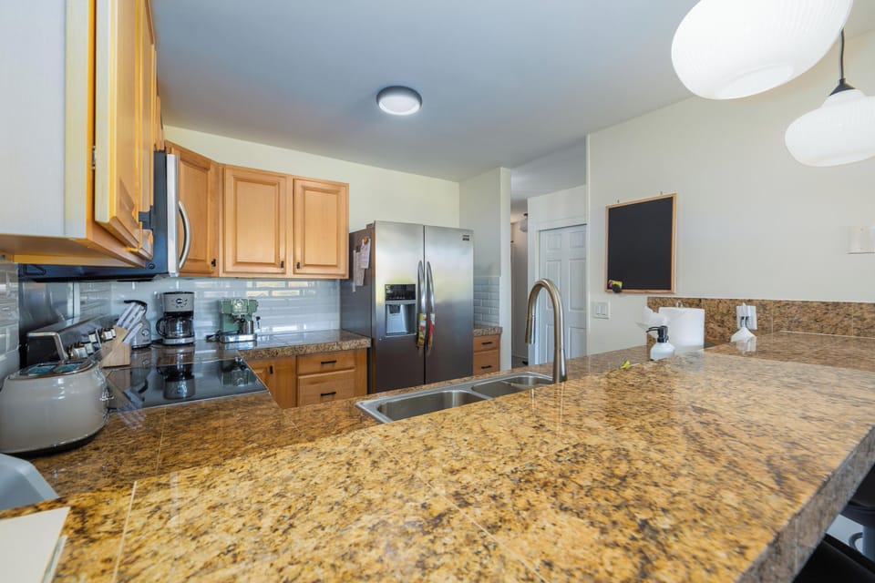 Functional kitchen with bar seating—well-stocked and ready
