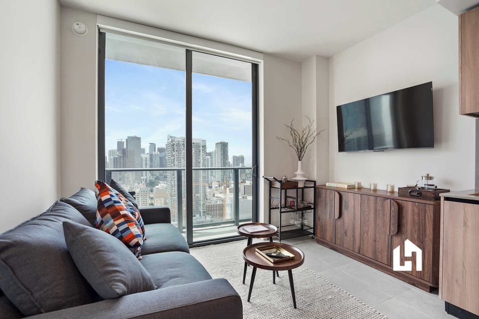 Comfortable seating with smart TV and city views