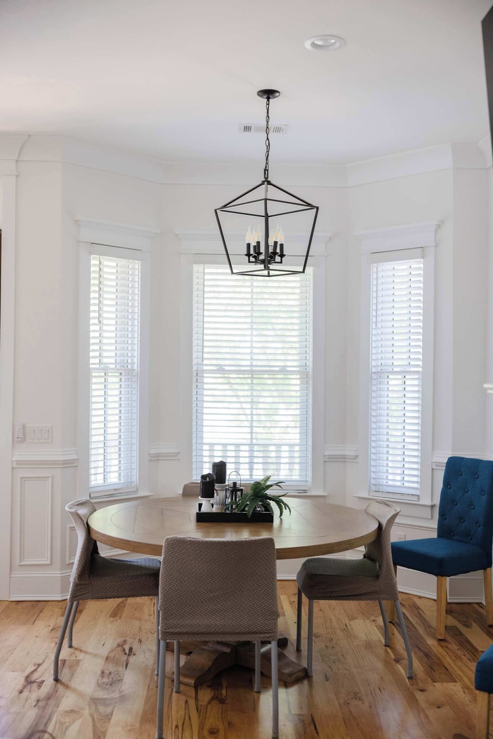 A dining table surrounded by windows offers the perfect spot to enjoy meals with a view and natural light!