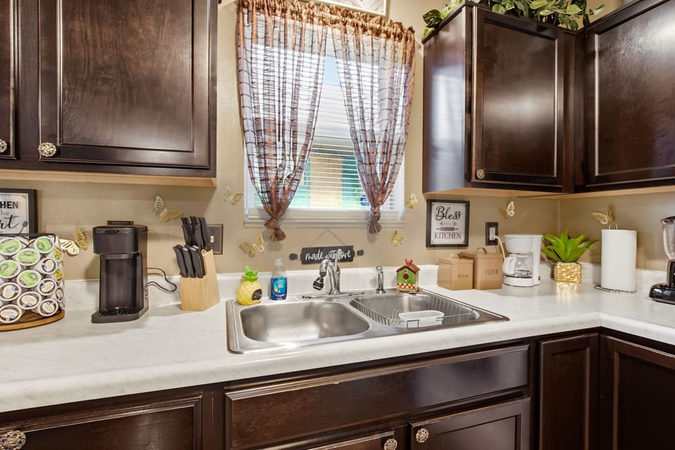 Charming, fully equipped kitchen with dark cabinets and modern appliances